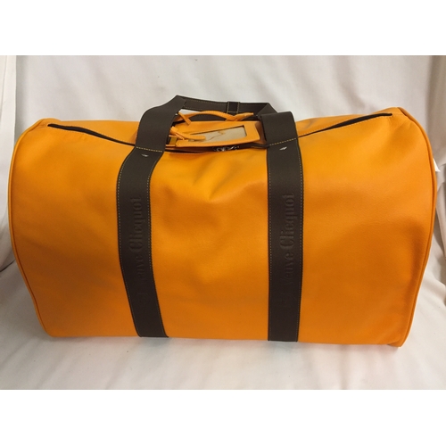 103 - BRAND NEW VEUVE CLICQUOT (VCP) ORANGE LEATHER WEEKEND TRAVEL BAG WITH SHOULD STRAP AND PROTECTIVE CO... 