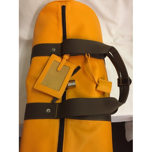 103 - BRAND NEW VEUVE CLICQUOT (VCP) ORANGE LEATHER WEEKEND TRAVEL BAG WITH SHOULD STRAP AND PROTECTIVE CO... 