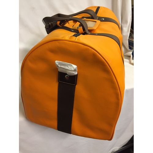 103 - BRAND NEW VEUVE CLICQUOT (VCP) ORANGE LEATHER WEEKEND TRAVEL BAG WITH SHOULD STRAP AND PROTECTIVE CO... 