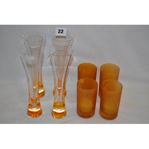 22 - FOUR VEUVE CLICQUOT SHAPED AMBER TINTED GLASSES AND FOUR VEUVE CLICQUOT CANDLE HOLDERS