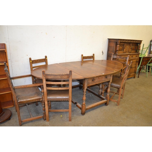 780 - REPRODUCTION CARVED OAK DINING SUITE COMPRISING GATE LEG DINING TABLE, 6 CHAIRS (4+2) AND COURT CUPB... 