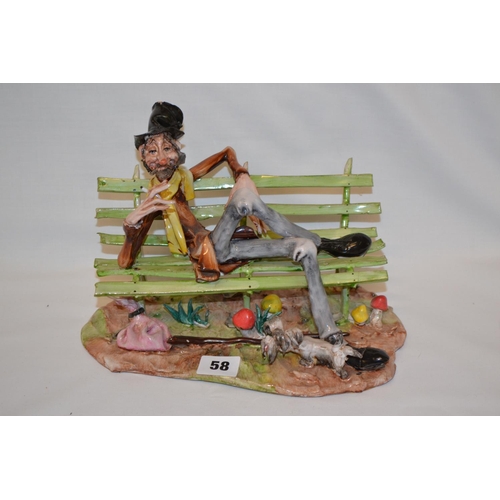 58 - GLAZED PORCELAIN CAPODIMONTE STYLE FIGURE OF TRAMP SMOKING ON A SLATTED BENCH WITH DOG (ONE SLAT ON ... 