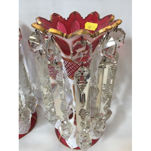 1 - PAIR OF VICTORIAN BOHEMIAN CUT GLASS CRANBERRY LUSTRES, OVERLAID WHITE AND GILT DECORATION, TRUMPET ... 