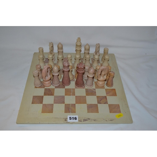 516 - SOUTH AFRICAN CARVED SANDSTONE CHESS SET AND BOARD (1 QUEEN MISSING)