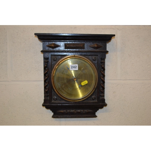 242 - EDWARDIAN OAK CASED ANEROID BAROMETER WITH CIRCULAR BRASS DIAL BY BELL & CO, NORTHAMPTON