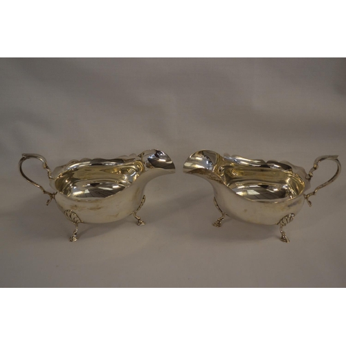 315 - PAIR OF SILVER SAUCE BOATS WITH SHAPED RIMS, SCROLL HANDLE ON 3 HOOF FEET; BIRMINGHAM 1930 (7.6oz)