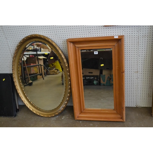 384 - RECTANGULAR PINE FRAMED WALL MIRROR 25CM X 57CM AND OVAL BEVELLED WALL MIRROR IN GILT FRAME