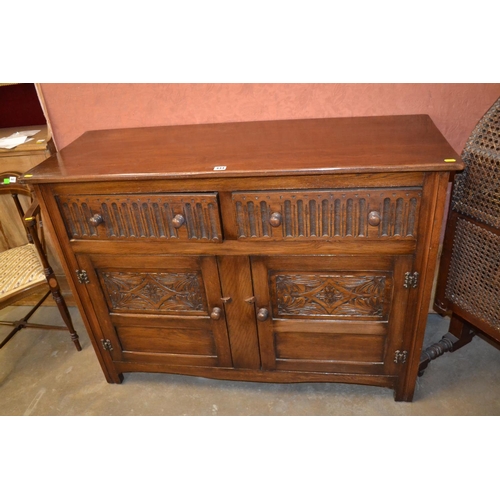 444 - REPRODUCTION CARVED OAK DRESSER BASE FITTED 2 DRAWERS WITH CUPBOARDS UNDER  121CM X 47CM X 90CM