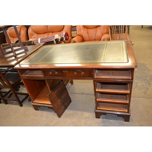 512 - REPRODUCTION MAHOGANY KNEEHOLE DESK FITTED 6 DRAWERS, DROP BRASS HANDLES AND CUPBOARD, TOOLED LEATHE... 