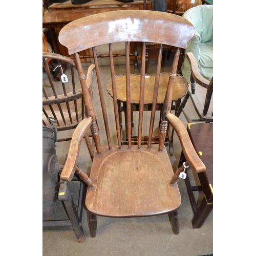 586 - 19TH CENTURY WINDSOR SPINDLE BACK ARMCHAIR