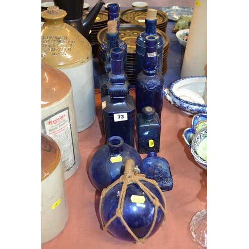 73 - 8 BLUE GLASS BOTTLES AND FLOAT