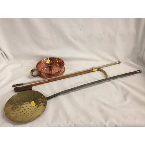 257 - 19TH CENTURY CIRCULAR COPPER CHAMBERSTICK, BRASS AND IRON SKIMMER, RIDING CROP AND WHIP