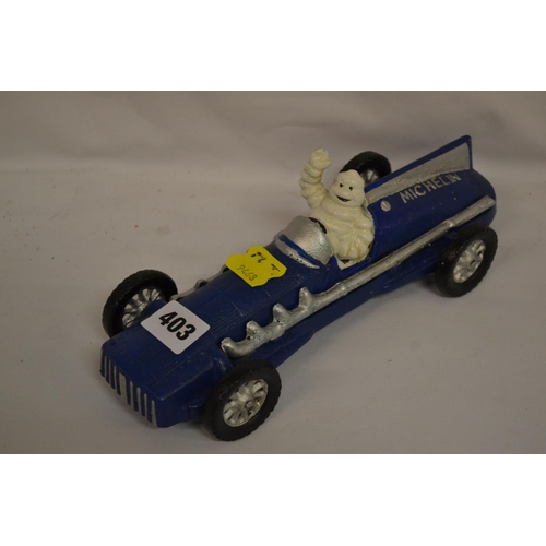 403 - CAST IRON MODEL OF MICHELIN MAN IN RACING CAR