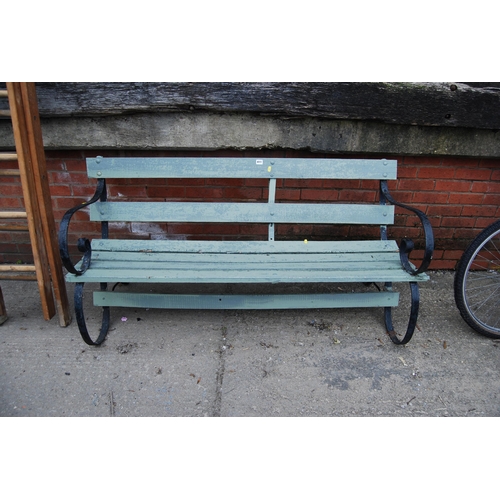 411 - WOODEN SLATTED GARDEN BENCH WITH WROUGHT IRON ENDS