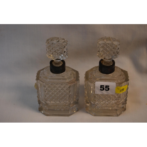 55 - PAIR OF GEORGIAN CUT GLASS SCENT BOTTLES WITH STOPPERS AND WHITE METAL RIMS