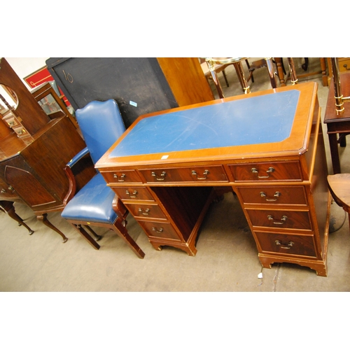 575 - REPRODUCTION MAHOGANY KNEEHOLE DESK FITTED 8 DRAWERS, DROP BRASS HANDLES, BLUE LEATHER TOP 109CM WID... 