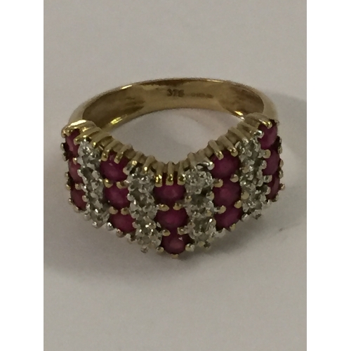 378 - 9CT GOLD RING SET 15 RUBIES AND 12 DIAMONDS (3.35g GROSS) SIZE L