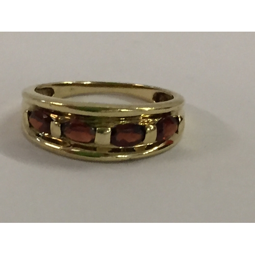 384 - 9CT GOLD RING SET 4 GARNETS (2.65g GROSS) SIZE O