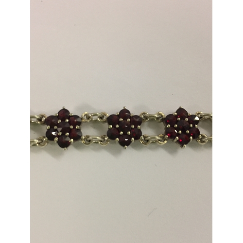 386 - FRENCH SILVER (900) AND GARNET BRACELET