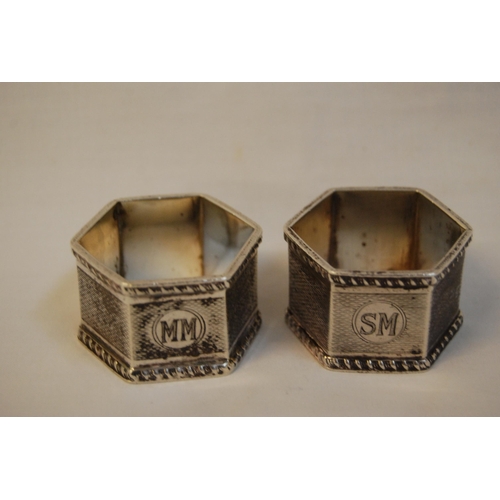 282 - PAIR OF HEXAGONAL ENGINE TURNED SERVIETTE RINGS WITH GADROONED RIMS (INITIALLED SM & MM), BIRMINGHAM... 