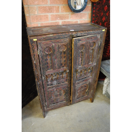 570 - 19TH CENTURY RICHLY DECORATED MOROCCAN CUPBOARD FITTED SHELF ENCLOSED BY PAIR OF PANEL DOORS 70cm X ... 