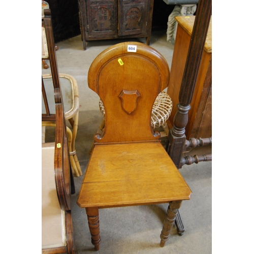 604 - 19TH CENTURY OAK HALL CHAIR WITH SHAPED & SHIELD BACK