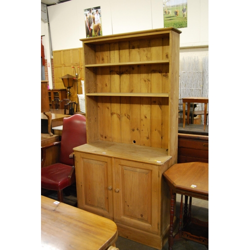 632 - PINE DRESSER FITTED CUPBOARD ENCLOSED BY PAIR OF PANEL DOORS, RACK OVER FITTED 2 ADJUSTABLE SHELVES