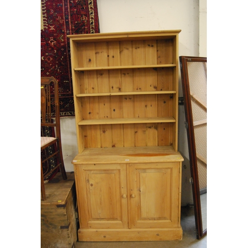 639 - PINE DRESSER FITTED CUPBOARD ENCASED BY PAIR OF PANEL DOORS, RACK OVER FITTED 3 ADJUSTABLE SHELVES