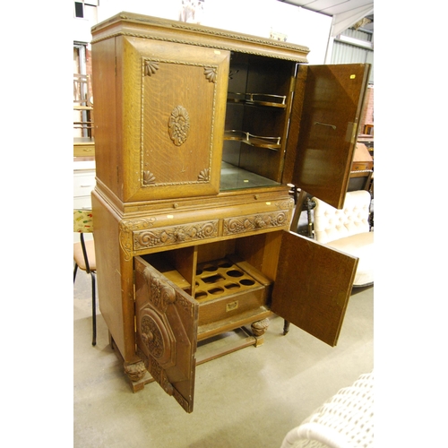 650 - 1930s CARVED OAK COCKTAIL CABINET WITH MIRRORED GLASS INTERIOR & SHAPED SHELVES, MIRRORED SLIDE, 2 D... 