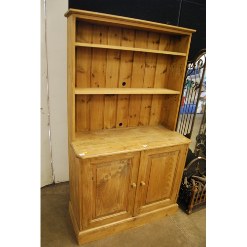 663 - PINE DRESSER WITH CUPBOARD ENCLOSED BY PAIR OF FIELDED PANEL DOORS, RACK OVER FITTED 2 ADJUSTABLE SH... 