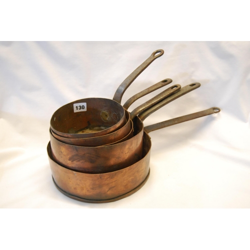 130 - GRADUATED SET OF FIVE 19TH CENTURY COPPER SAUCEPANS WITH IRON HANDLES