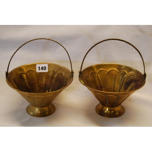 140 - PAIR OF FLUTED BRASS BASKETS WITH ROPE TWIST HINGED HANDLES