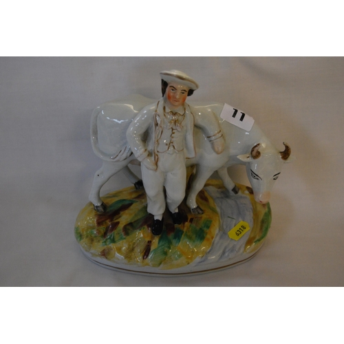 11 - 19TH CENTURY STAFFORDSHIRE GROUP OF COW & FARMER (21cm)