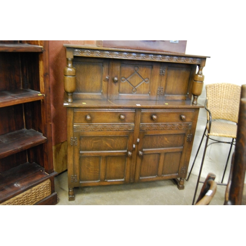 582 - REPRODUCTION CARVED OAK COURT CUPBOARD