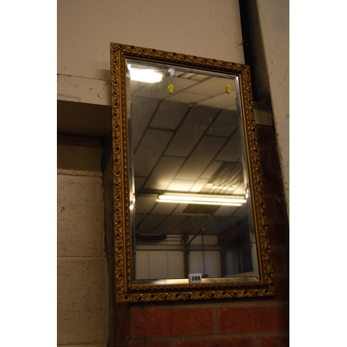 599 - BEVELLED GLASS WALL MIRROR IN PIERED ACANTHUS FRAME