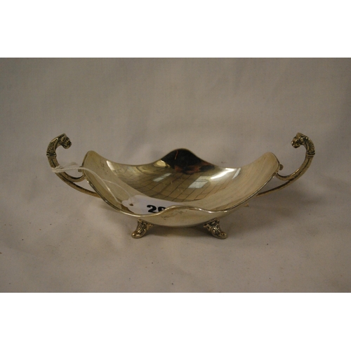 261 - WHITE METAL BOAT SHAPED DISH WITH GRIFFON HANDLES ON ACANTHUS FEET