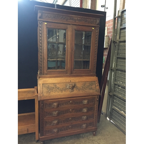 753 - ARTS AND CRAFTS CARVED OAK BUREAU / BOOKCASE WITH FITTED INTERIOR, FALL FLAP, CARVED FLOWERS, 4 DRAW... 