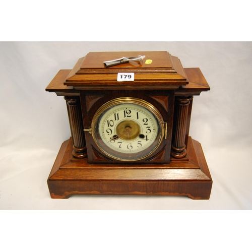 179 - EDWARDIAN OAK MANTLE CLOCK WITH FLUTED PILLAR SUPPORTS (8 DAY)