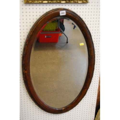 360 - EDWARDIAN OVAL BEVELLED GLASS WALL MIRROR IN OAK FRAME