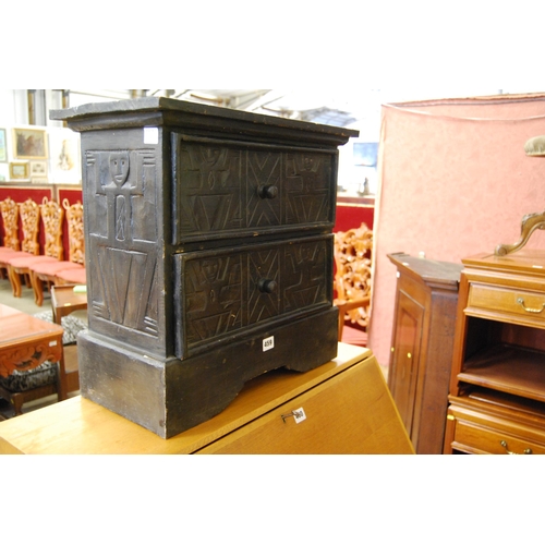 459 - SMALL EBOINISED SOUTH AMERICAN CHEST OF 2 DRAWERS, CARVED WITH AZTEC DECORATION (53cm X 28cm X 50cm)