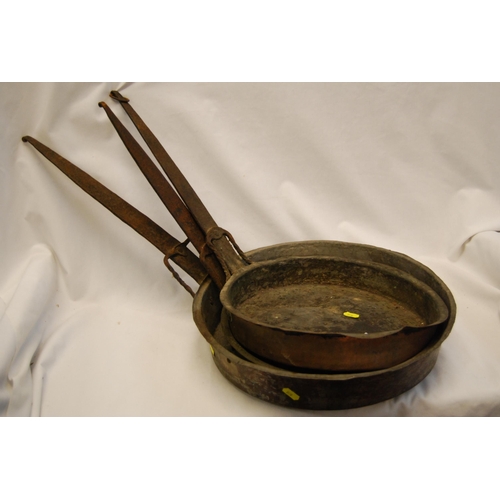 257 - THREE 19TH CENTURY COPPER PANS WITH LONG IRON HANDLES