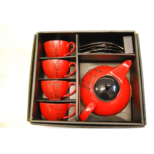 29 - RED GROUND ORIENTAL STYLE TEAPOT AND 4 CUPS & SAUCERS, MADE FOR THE PIER, BEIJING