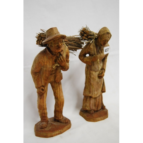 437 - PAIR OF CARVED WOODEN FIGURES OF WOODMAN & WIFE CARRYING STICKS