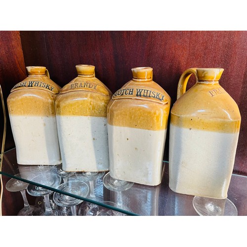 46 - A set of 3 earthenware jugs, Brandy, Irish Whisky, Scotch Whisky and one other