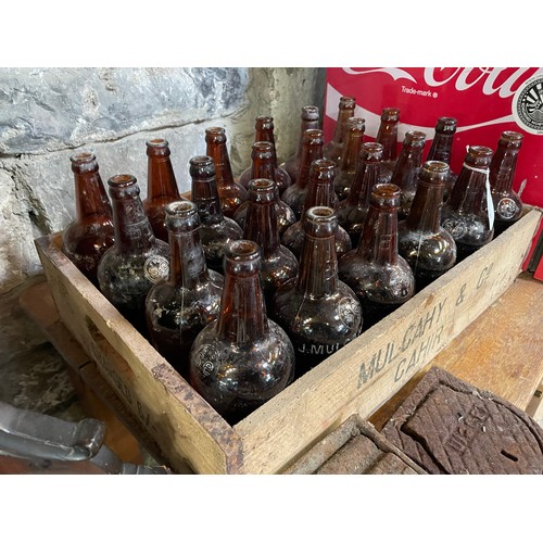 295 - Mulcahy of Cahir old timber crate and 24 matching brown bottles