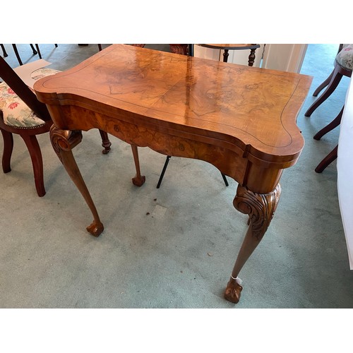 202 - A pair of Edwardian Walnut fold over card tables on ball and claw Chippendale feet. Circa 1900