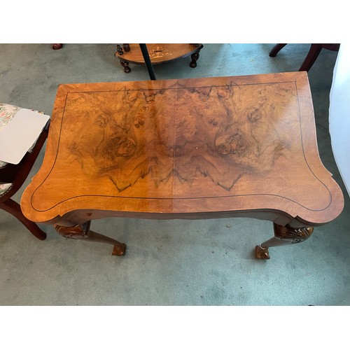 202 - A pair of Edwardian Walnut fold over card tables on ball and claw Chippendale feet. Circa 1900