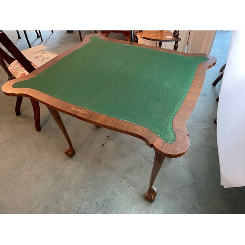 202 - A pair of Edwardian Walnut fold over card tables on ball and claw Chippendale feet. Circa 1900