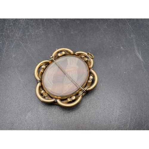 70 - Early Victorian quality mourning broach with revolving centre piece with a woven lock of hair on one... 