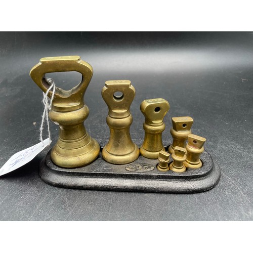 284 - Set of brass postal weights on metal base